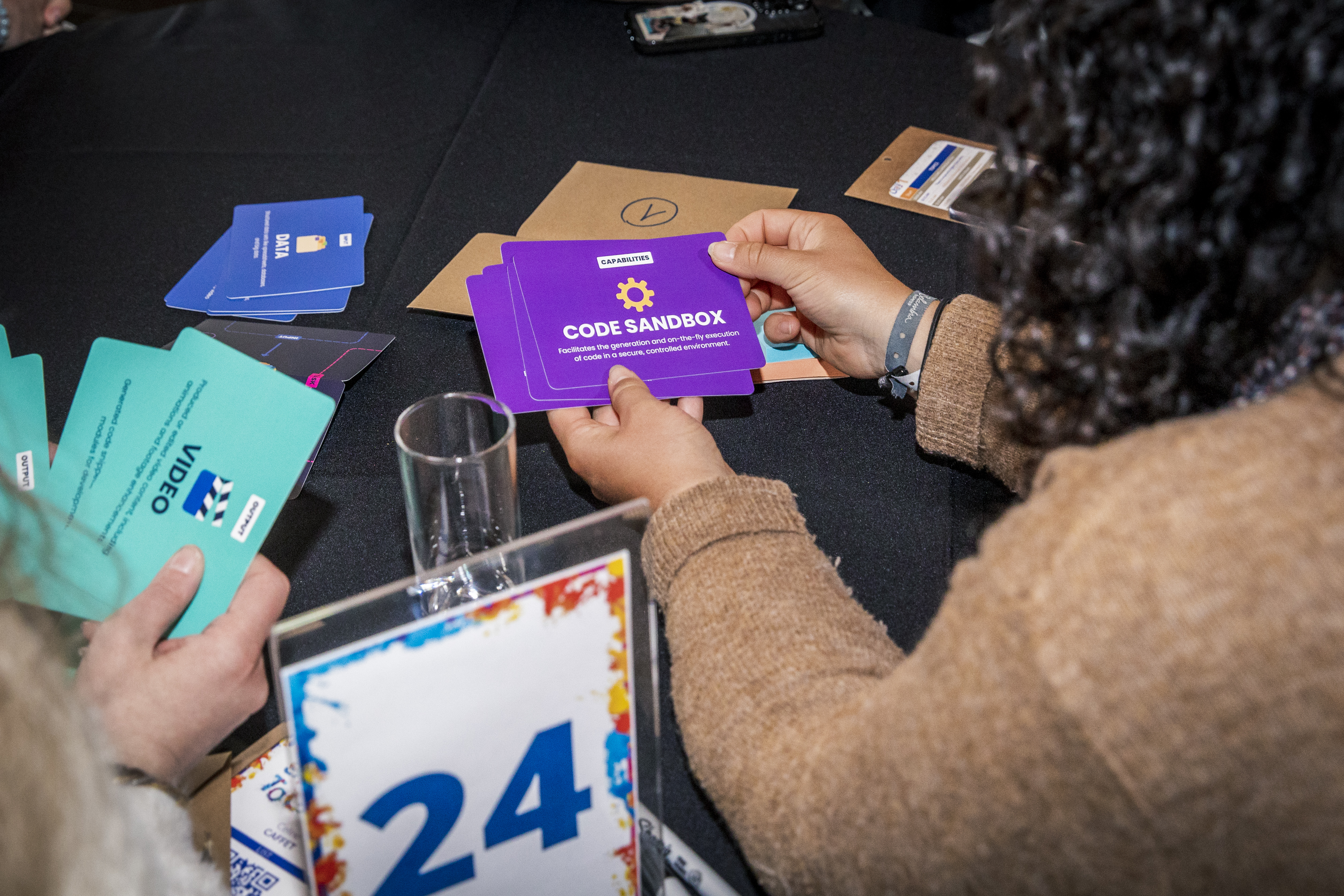 Photo of participants exploring output and capability cards from the AI Tinkerer's Cards